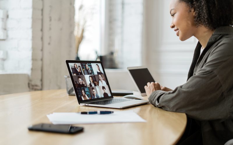 Video communication woman with colleagues freelancer workplace uses laptop computer